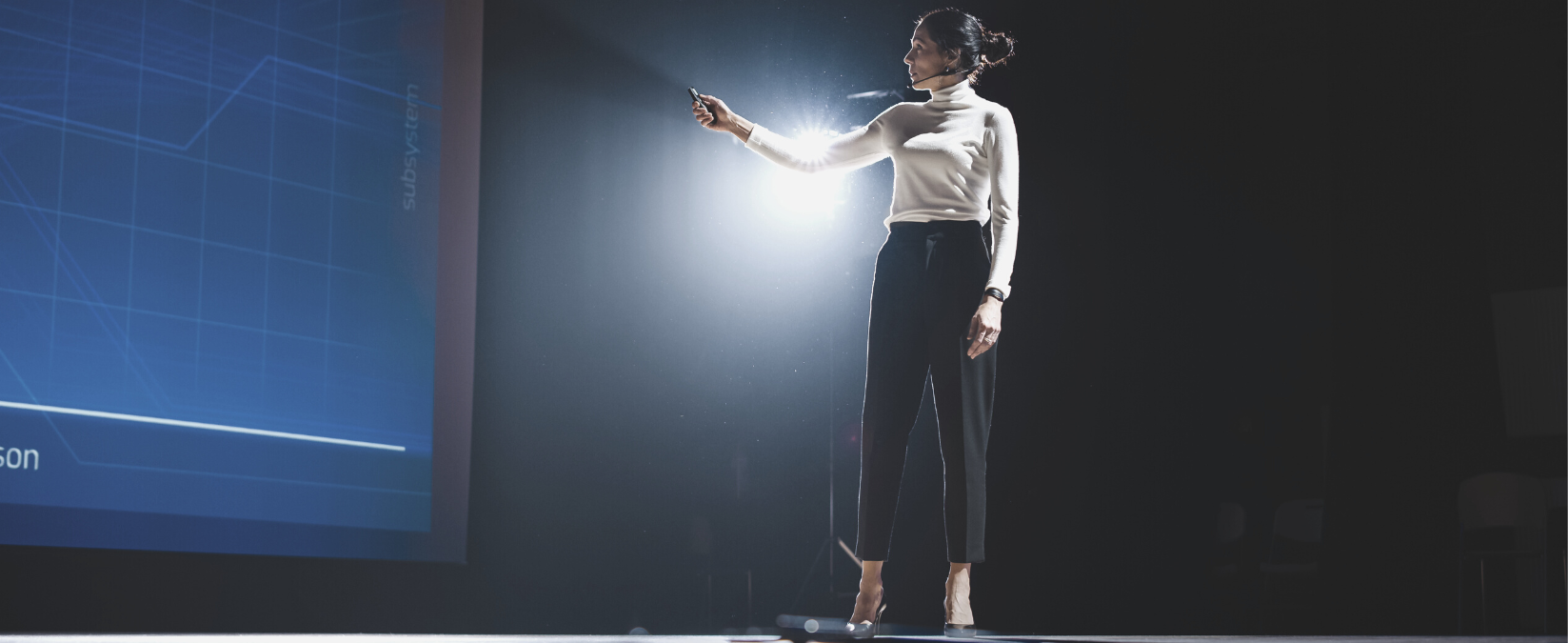 Female Leader teaching in front of the audience